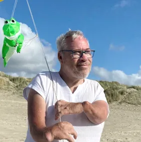 Michels_Klaus Photo of a middle-aged man on a beach with a kite